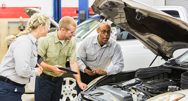 istock Team of multi-racial auto mechanics working on a car 508701240