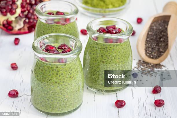 Chia Seed Pudding With Matcha Green Tea Garnished With Pomegranate Stock Photo - Download Image Now