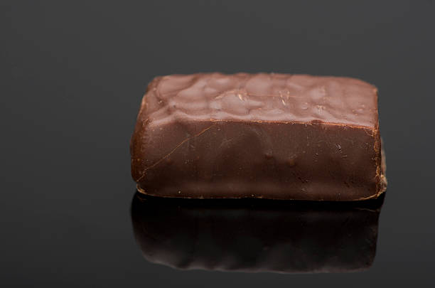 istock Close up of chocolate bar isolated on black background. Reflection. 508702012