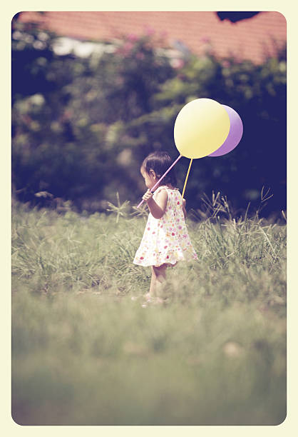 istock little girl playing balloon 508703472
