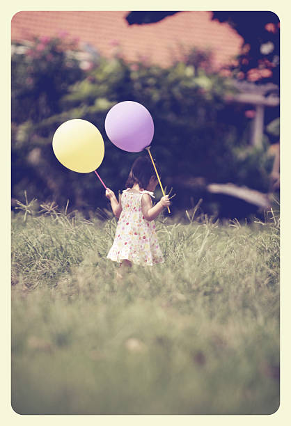 istock little girl playing balloon 508703506