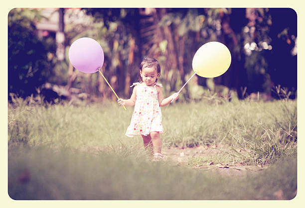 istock little girl playing balloon 508703508