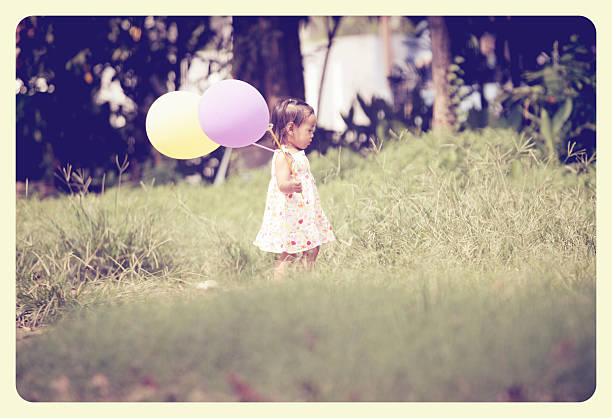 istock little girl playing balloon 508703514