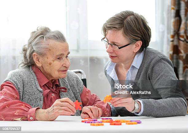 Senior Woman With Her Elder Care Nurse Stock Photo - Download Image Now - Dementia, Adult, Assistance