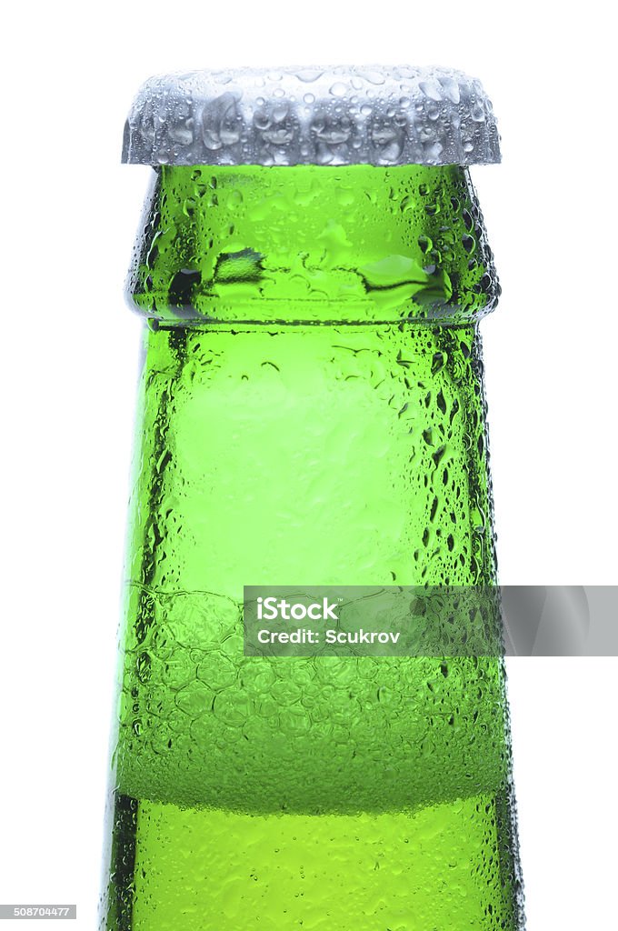 Macro Shot of Green Beer Bottle Neck Macro shot of a green beer bottle neck and cap with condensation. Vertical format over a white background. Alcohol - Drink Stock Photo