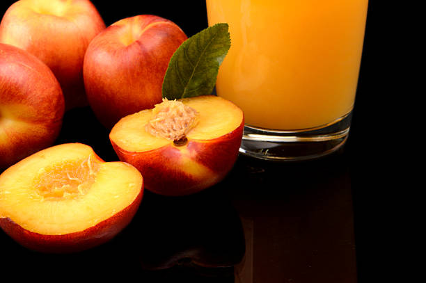 istock Close-up shot sliced orange nectarines with juice and leaf 508704625