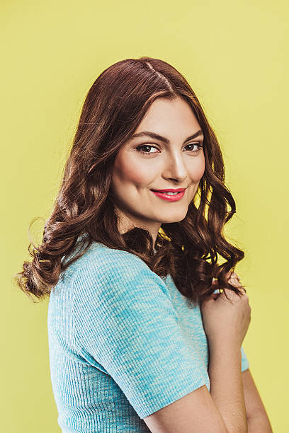 istock Beautiful young woman in pastel on yellow 508704896