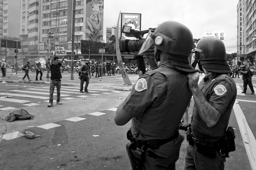 São Paulo, Brazil, January, 12, 2016: Riot police filming the action of protesters during act on Paulista Avenue against the increase in tariffs in urban transport