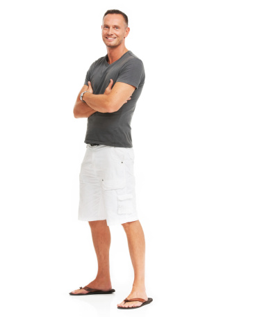 Smiling mature man standing isolated on white - full-length