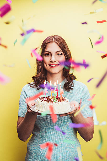 Beautiful young woman celebrating birthday with cake Beautiful young woman celebrating birthday with cake with candles woman birthday cake stock pictures, royalty-free photos & images