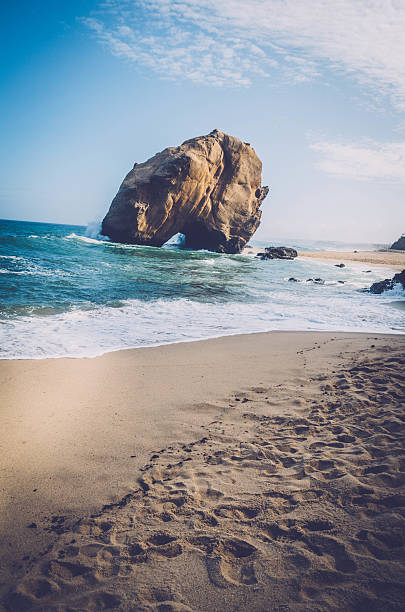 Penedo do Guincho - Santa Cruz Beach, near Lisbon, Portugal: towering rock 98 feet high and 328 feet in circumference with a crack at its base.