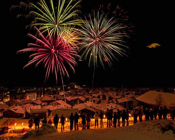 In Saas-Fee, Swiss Alps, new year is celebrated with a large display of fireworks shot in the sky from all corners of the village. People with torches seek high ground to watch the show.
