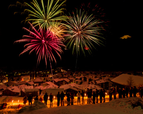 In Saas-Fee, Swiss Alps, new year is celebrated with a large display of fireworks shot in the sky from all corners of the village. People with torches seek high ground to watch the show.