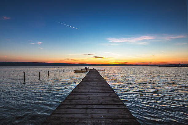 Beautiful cloudscape over the lake and blured boat
