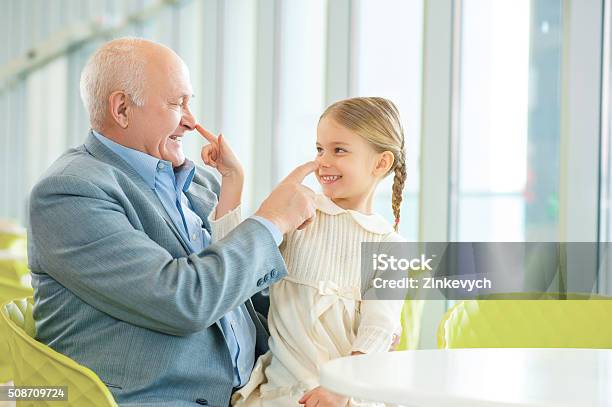 Grandfather Meeting His Cute Granddaughter Stock Photo - Download Image Now - Adult, Awe, Child