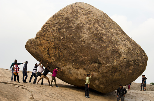 Mahabalipuram, India - 06 Feb 2016 : Few people try to push the big boulder