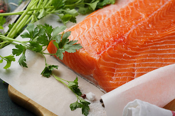 istock cooking raw salmon and fresh greens 508713242
