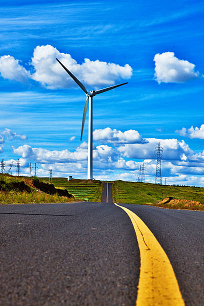 istock Power Generating Windmills and road 508724859