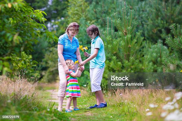 Young Grandmother With Grandchildren Hiking In A Pine Wood Stock Photo - Download Image Now