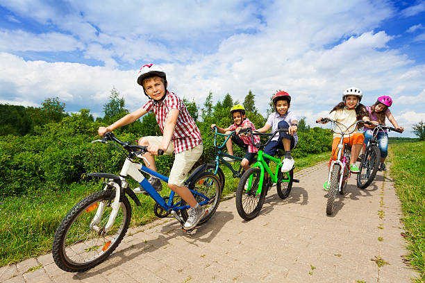 istock Kids in helmets riding bikes together 508726695