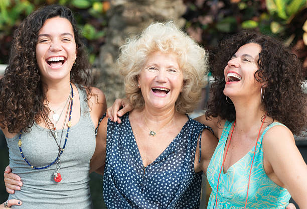 Three Generations Women Grandmother, mother and daughter laughing together grandmother real people front view head and shoulders stock pictures, royalty-free photos & images
