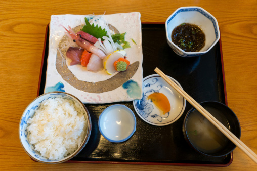 Traditional Japanese sushi dinner with a small miso soup.