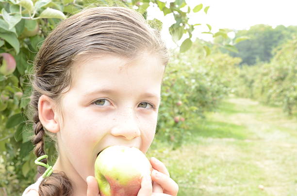 istock Happy girl biting an apple 508732033