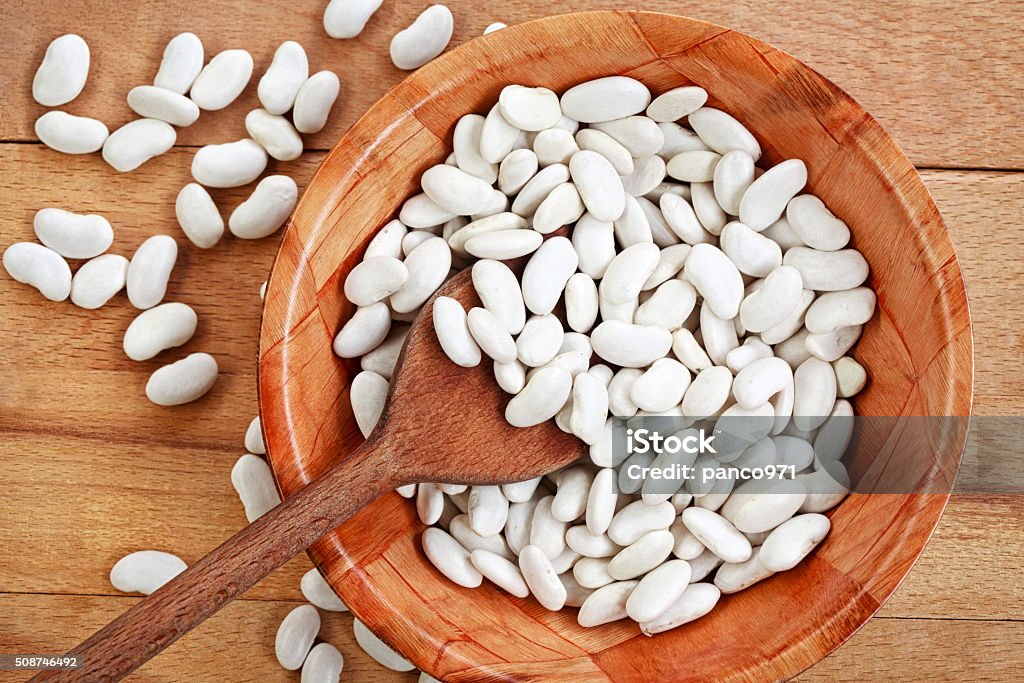 White beans on a wooden board White beans on a wooden board-vegetables-organic Bean Stock Photo