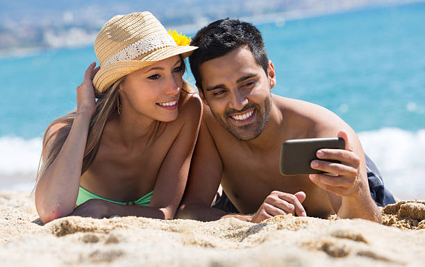 istock Happy couple taking photo on the beach 508748708