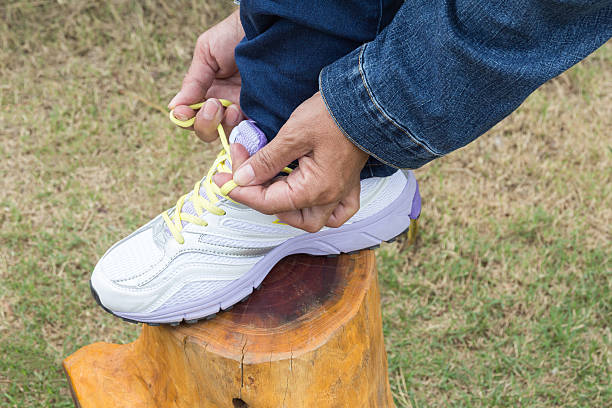 istock Female tying laces for jogging on road 508748996