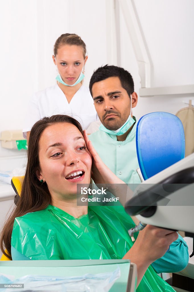 Patient visiting dental clinic Young female patient visiting dentist in the dental clinic 25-29 Years Stock Photo
