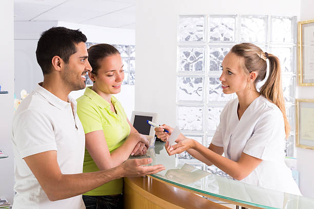 istock Couple with receptionist at clinic 508750120
