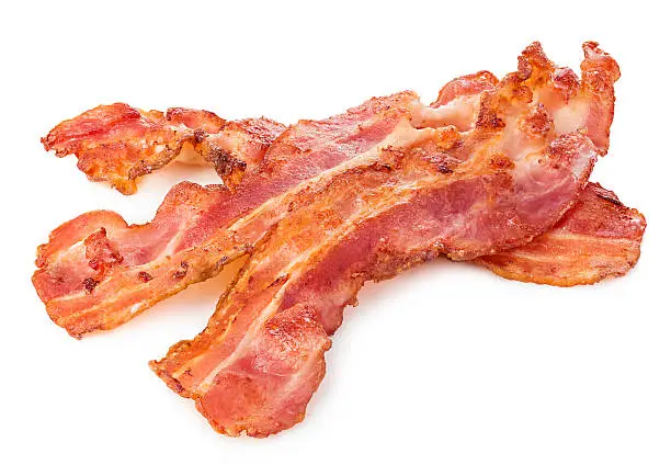 Photo of Cooked bacon rashers close-up isolated on a white background.