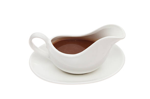 Gravy Gravy in a gravy boat isolated against white gravy photos stock pictures, royalty-free photos & images