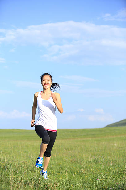 istock Runner athlete running on sunrise/sunset grass field 508757141
