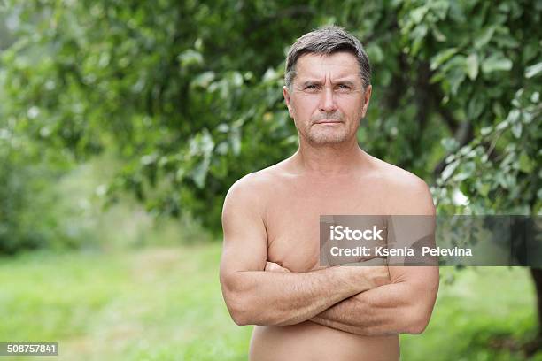 Portrait Of Middleaged Men On The Background Of Green Foliage Stock Photo - Download Image Now