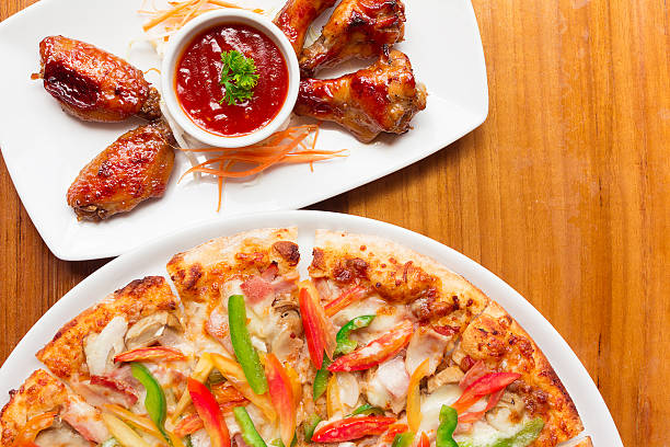 Delicious fresh pizza served Chicken Wings on wood background