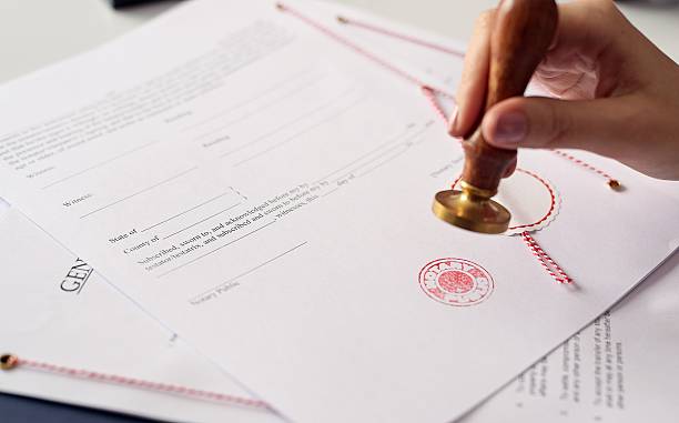 Close up on woman's notary public hand  stamping the document