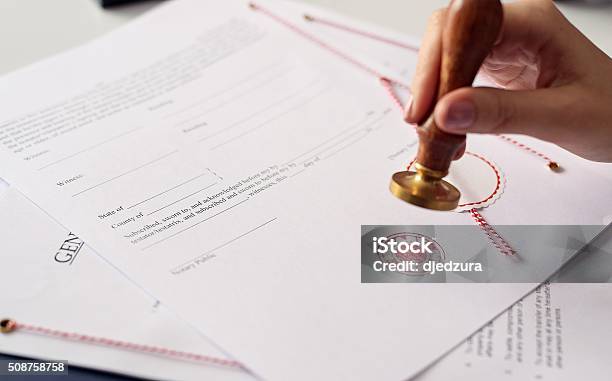 Close Up On Womans Notary Public Hand Stamping The Document Stock Photo - Download Image Now