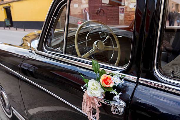 istock flowers decorating an old black luxury car 508759187