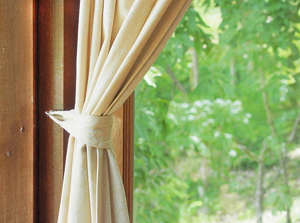 istock beige curtain and green window view 508759189