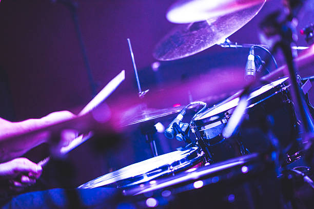 Playing drums on a rock concert Detail shot of drums on a stage on rock concert. There is also some fog in the air. Scene is illuminated with strong blue stage light. bass drum photos stock pictures, royalty-free photos & images