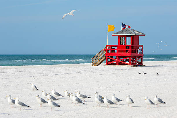 Red wooden lifeguard hut on an empty morning beach