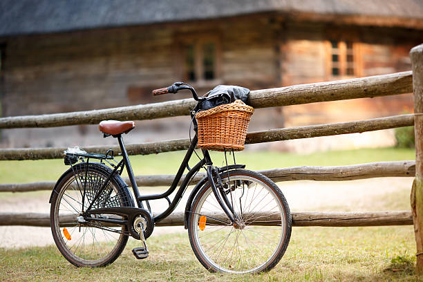 Old rusty bicycle with basket in countryside
