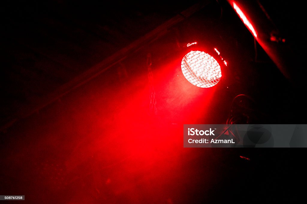 Beam of light Red beam of light in the dark. There is some steel frame seen in back. Shot on a rock concert. Red Stock Photo