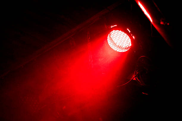 Beam of light Red beam of light in the dark. There is some steel frame seen in back. Shot on a rock concert. disco lights stock pictures, royalty-free photos & images