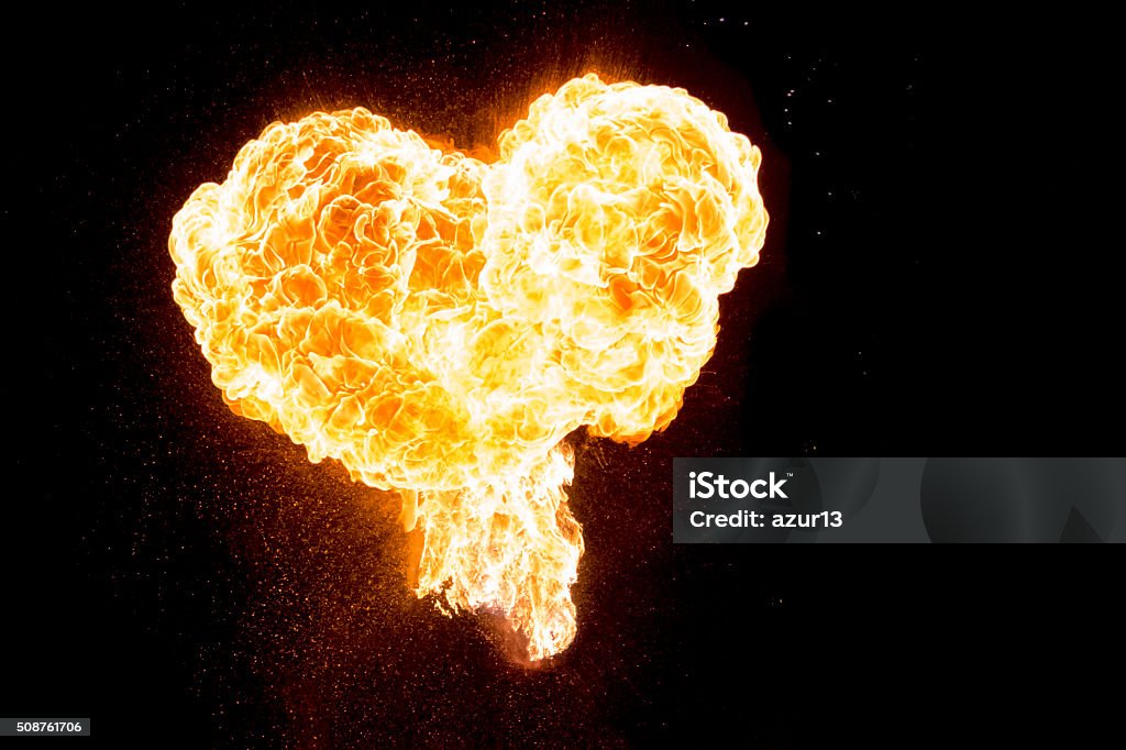 Red orange hot fire love heart isolated on black background Wonderful perfect heart shape symbol for visualizing e.g. Valentine's Day, love, passion, hope, fight, friendship, power, health or energy. Fire - Natural Phenomenon Stock Photo