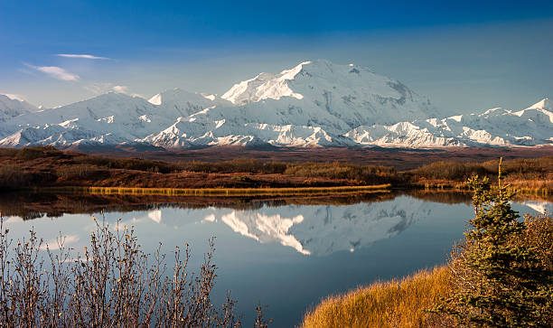 Denali Mountain in Fall Reflected in Wonder Lake, Alaska Denali Mountain in Fall Reflected in Wonder Lake foothills photos stock pictures, royalty-free photos & images