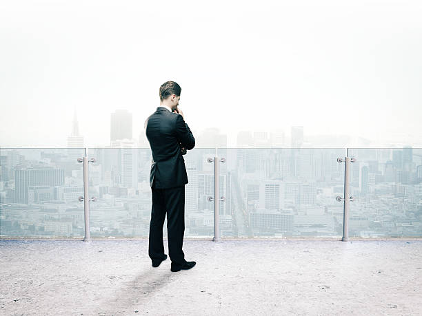 istock businessman thinking standing on roof 508764288