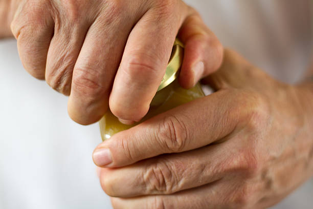 istock Strong Male Hands Twisting a Stubborn Jar Lid (Close-Up) 508785249
